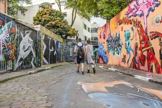 Mural-Lined Alley with Two Walkers