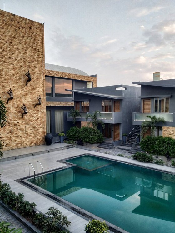 Courtyard Pool Between Brick and Timber Houses