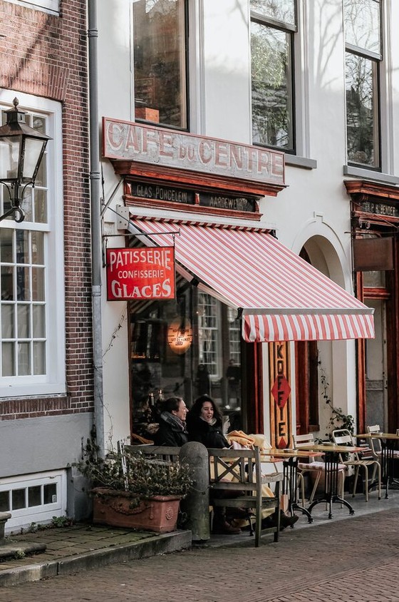 People at a café terrace on a Dutch town street
