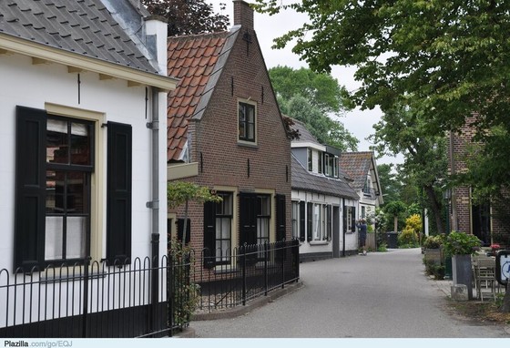 Brick houses lining a quiet Dutch village street