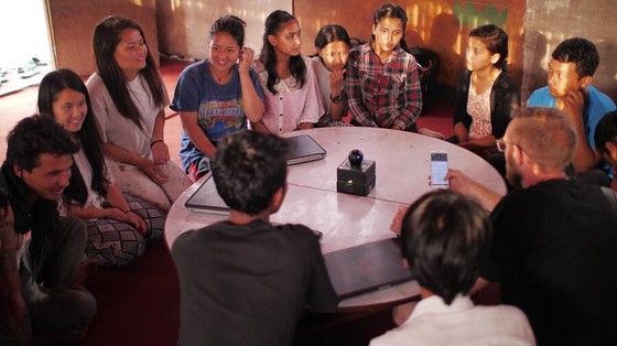 Young People Gathered Around a Projector