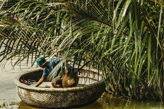 Fisher in a Round Basket Boat Among Palms